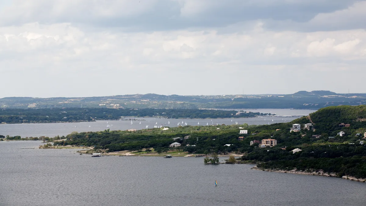Lake Travis at full capacity with sailboats and waterfront homes near Lakeway, Texas